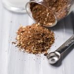 Homemade Taco Seasoning spilled out of a glass jar