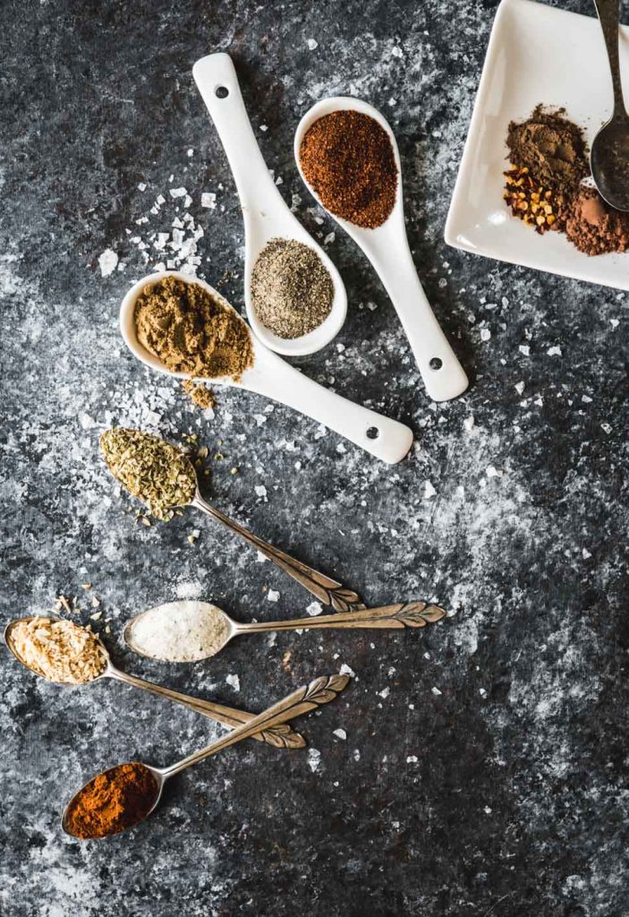 Taco seasoning spices on small spoons 