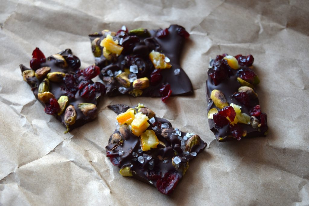 Pieces of dark chocolate bark on light brown parchment paper