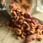 Homemade Honey Flax granola being poured out of a jar.