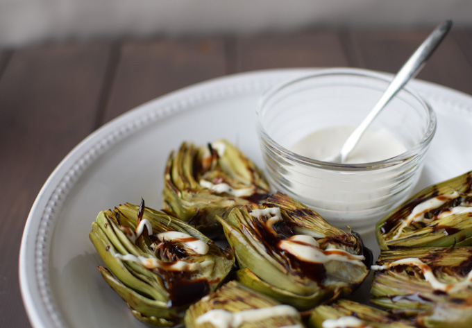 Grilled Baby Artichokes cut in half and drizzled with balsamic glaze