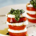 Close up of tomato, mozzarella and basil pesto stack