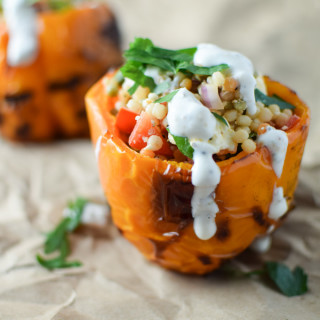 Grilled pepper stuffed with pearl couscous and drizzled with yogurt sauce