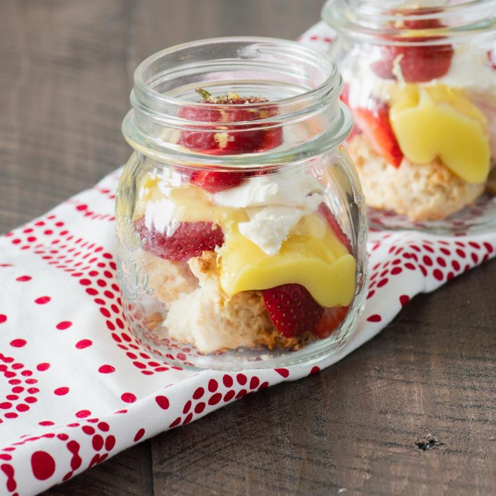 Desconstructed strawberry shortcake with lemon curd in a small mason jar