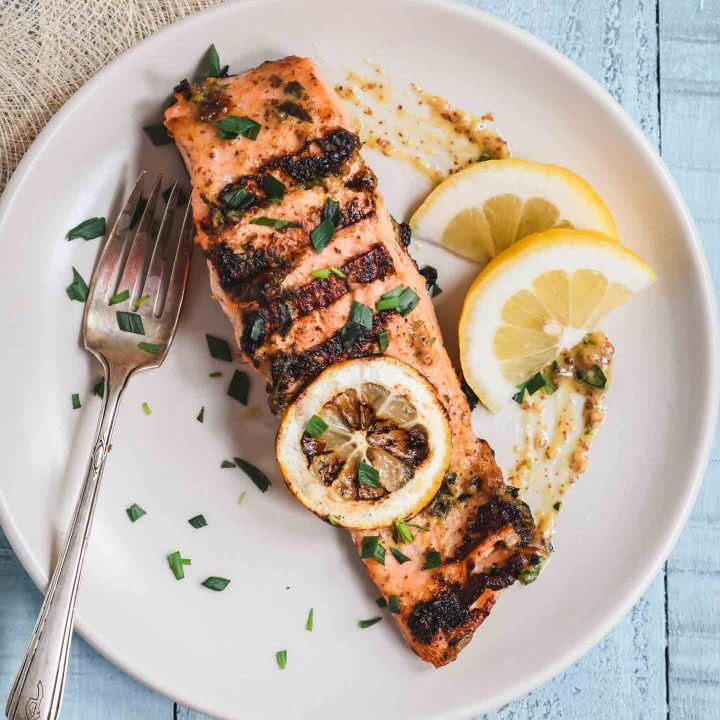 Grilled salmon filet topped with a grill lemon slice