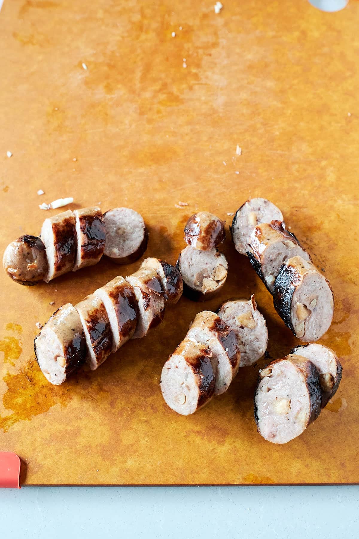 Sausage link sliced into rounds on a cutting board