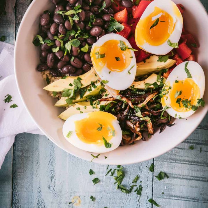 quinoa topped with avocados, black beans, caramelized onions and jammy eggs