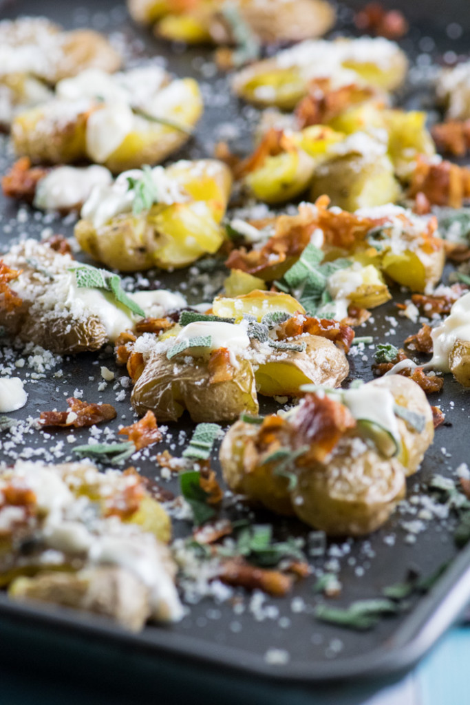 Close up of smashed fingerling potatoes sprinkled with parmesan cheese