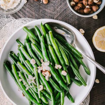 Green beans in a low white dish shot from overhead