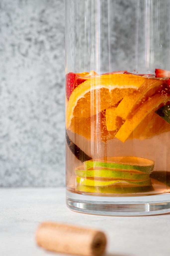 Close up of sangria pitcher filled with sliced fruit