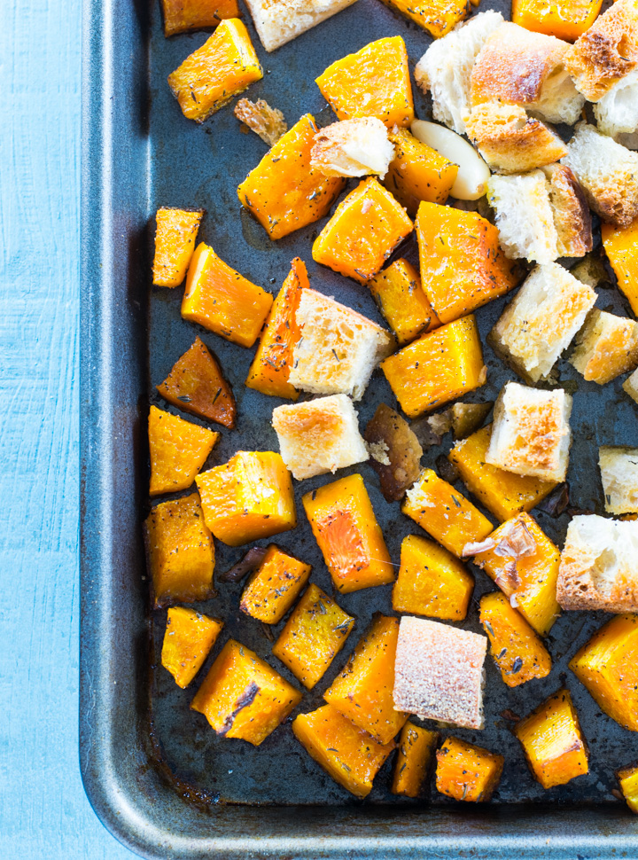 Butternut squash and sourdough bread cubes on a sheet pan