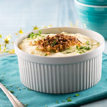 Mashed potatoes topped with crispy onions in a casserole dish