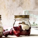 Quinoa in a mason jar topped with cranberry sauce and yogurt