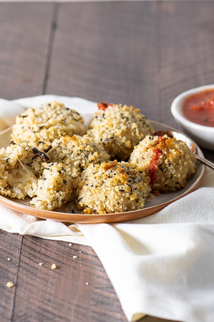 Baked mushroom arancini balls topped with tomato sauce