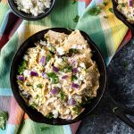 Chilaquiles verde in a black cast iron skillet