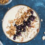 Peach Protein Smoothie Bowl topped with toasted almonds, granola and blueberries