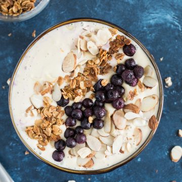 Peach Protein Smoothie Bowl topped with toasted almonds, granola and blueberries