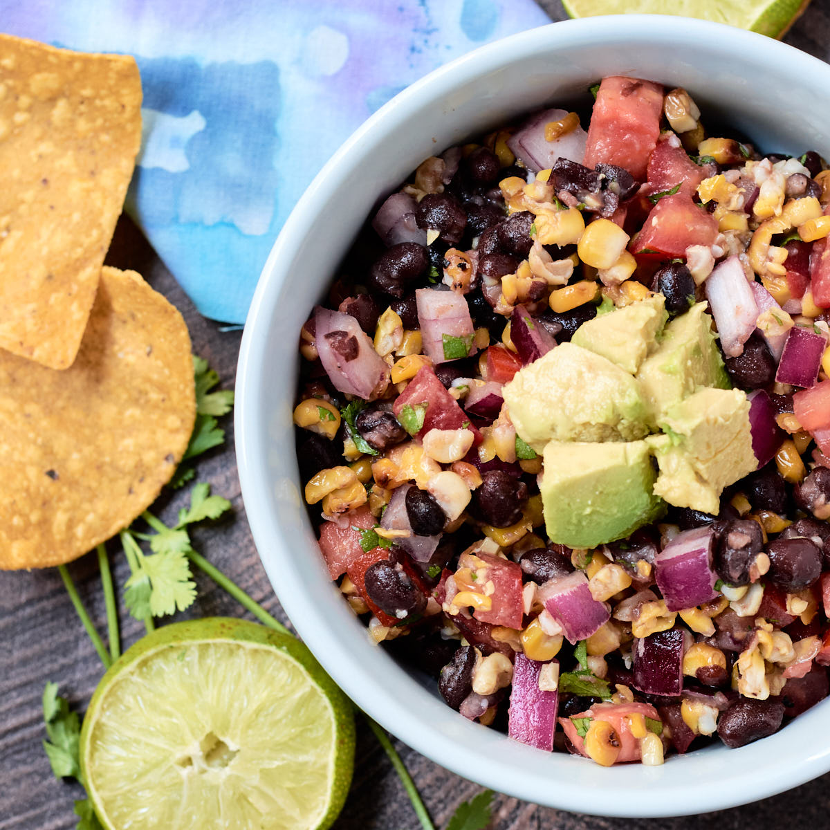 Overhead shot of corn and black bean salsa in a blue bowl