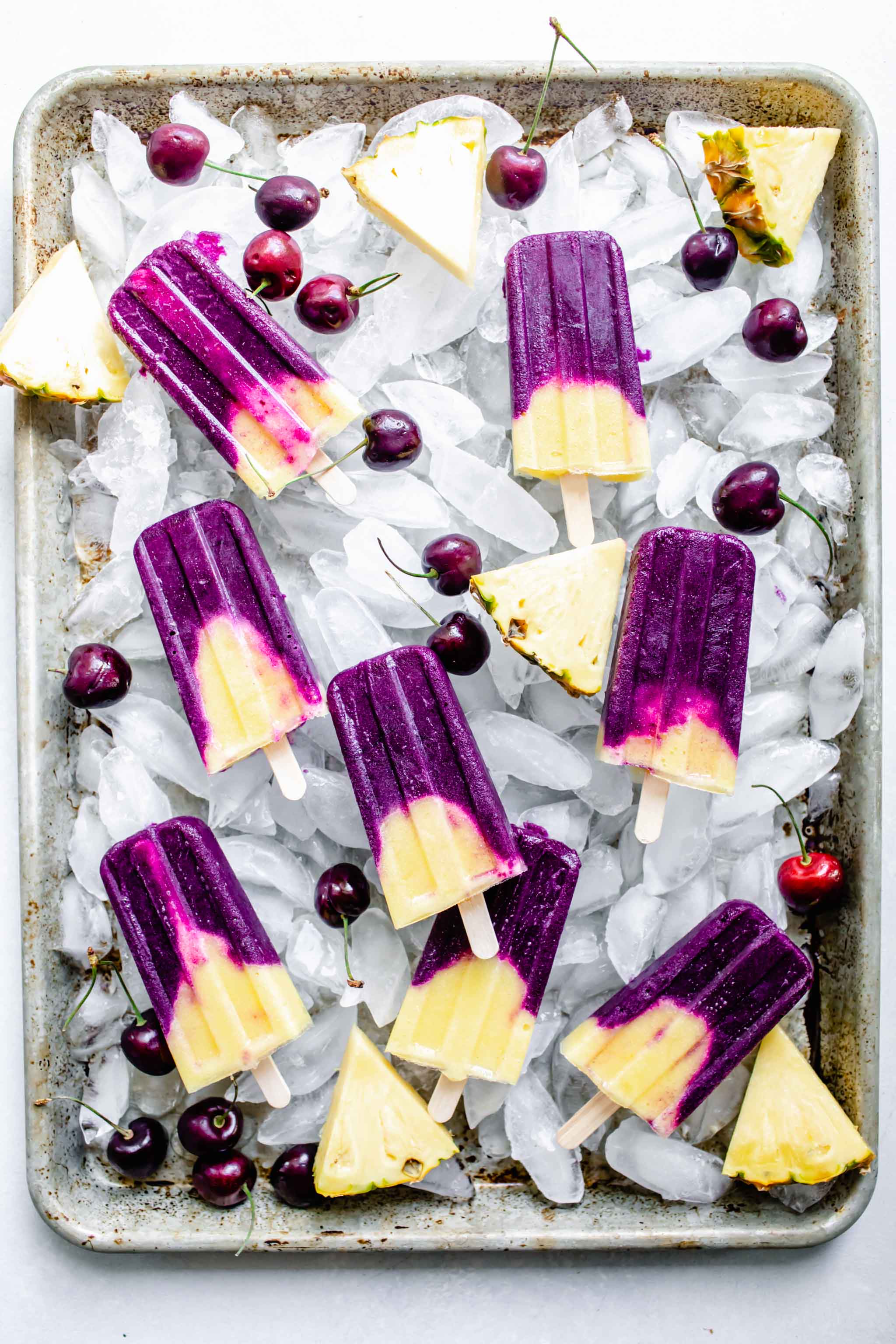 Cherry pineapple popsicles on a bed of ice