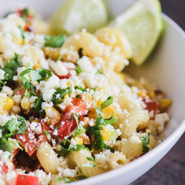White bowl filled with Mexican Street corn pasta salad