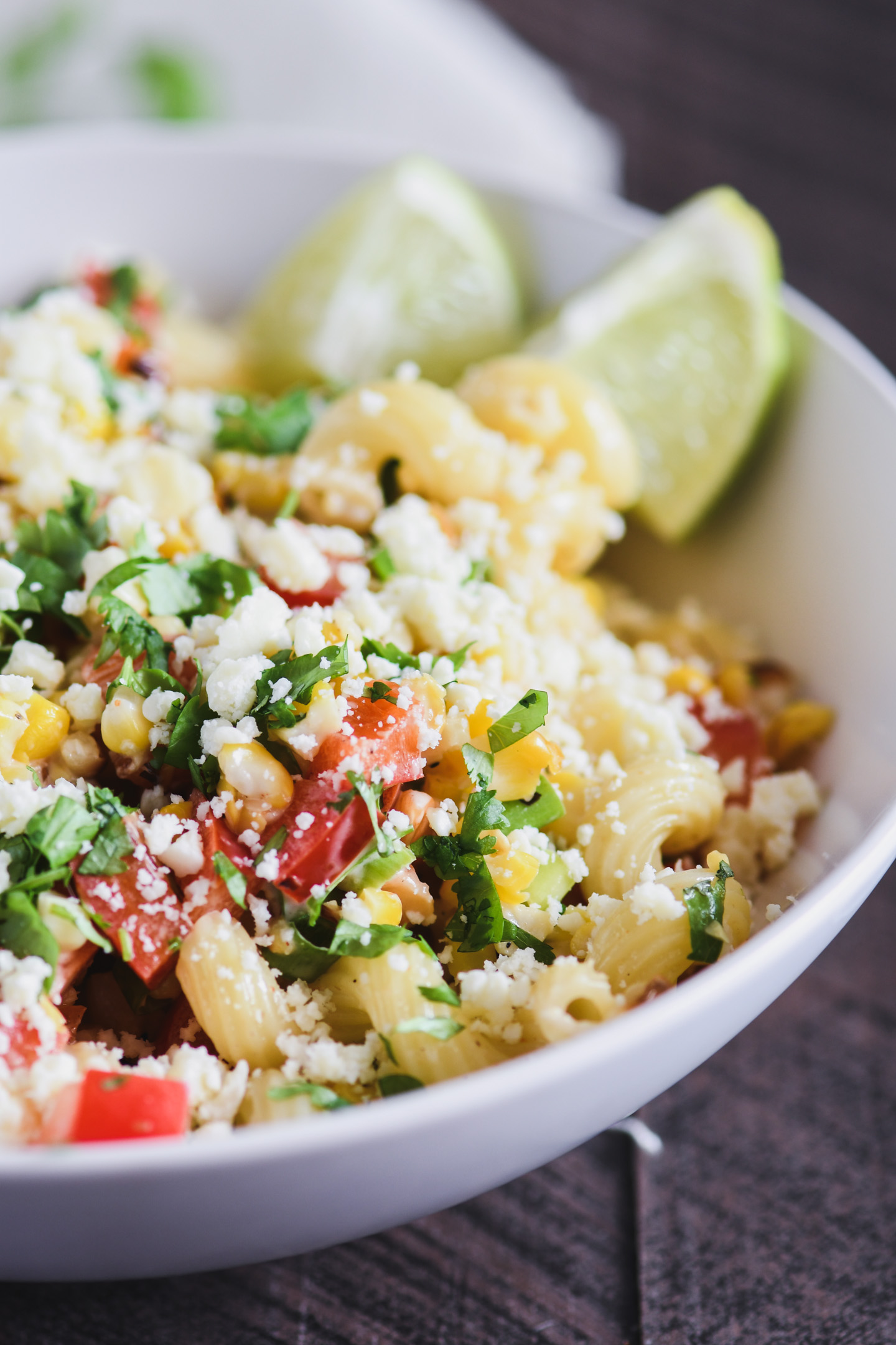 White bowl filled with Mexican Street corn pasta salad