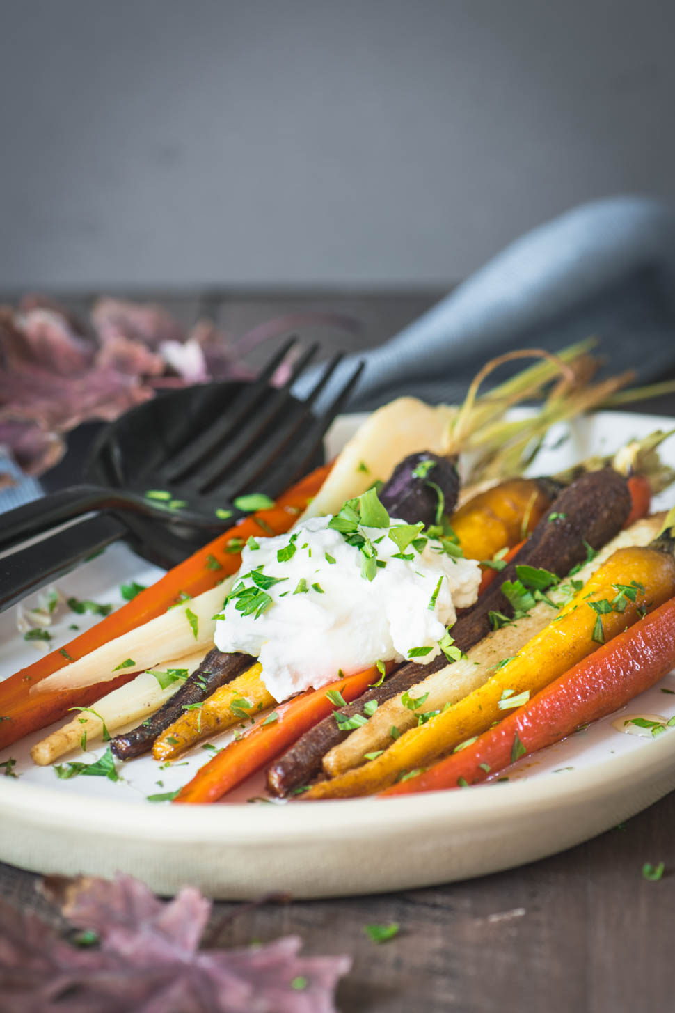 Tri-color roasted carrots on a cream plate
