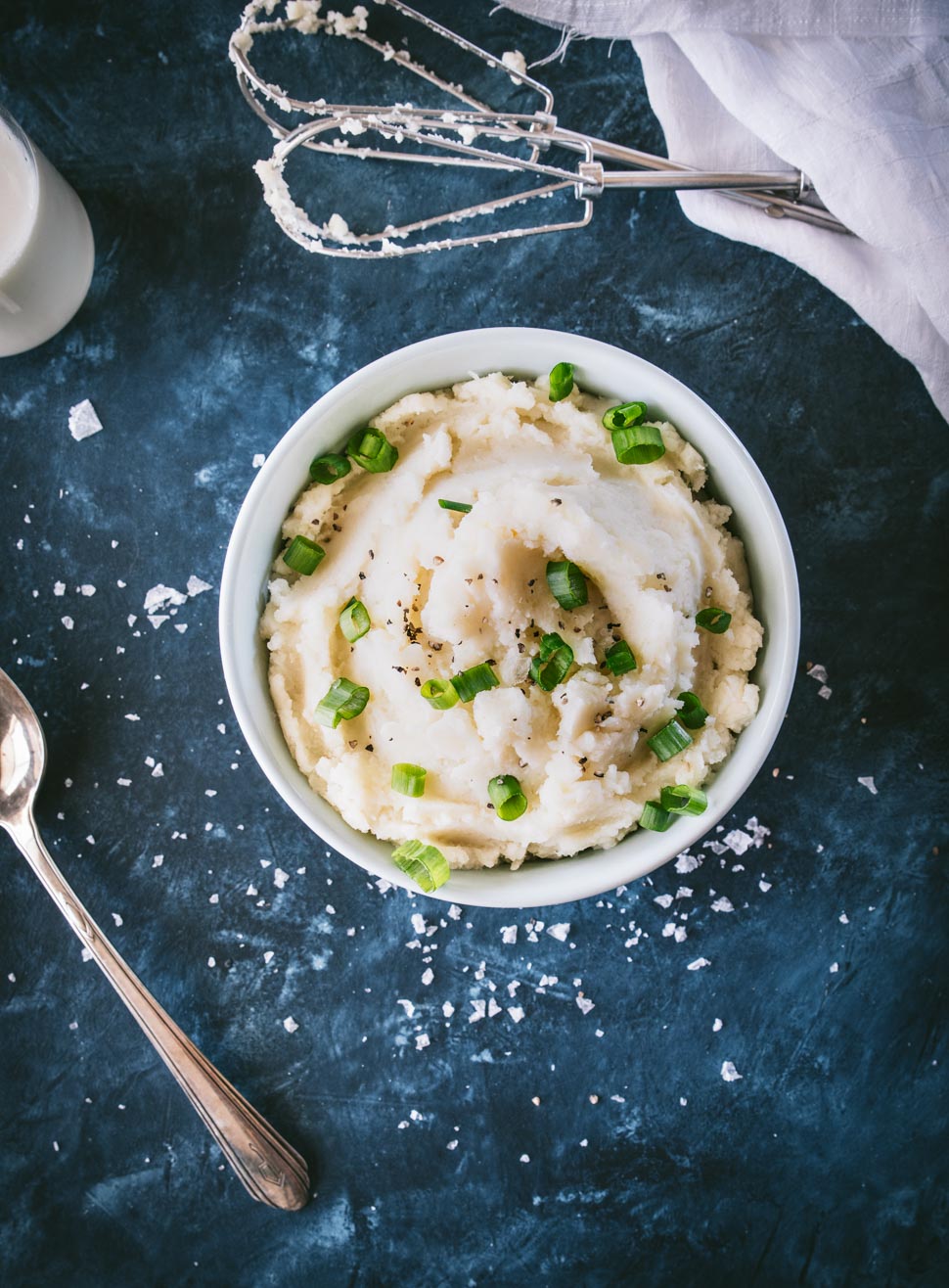Parmesan Cauliflower Mashed Potatoes in a bowl on a blue background shot from overhead