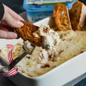 This creamy Sun-dried Tomato Asiago Cheese Dip has only 5 ingredients and is the perfect solution for a quick holiday party appetizer when entertaining friends and family! 