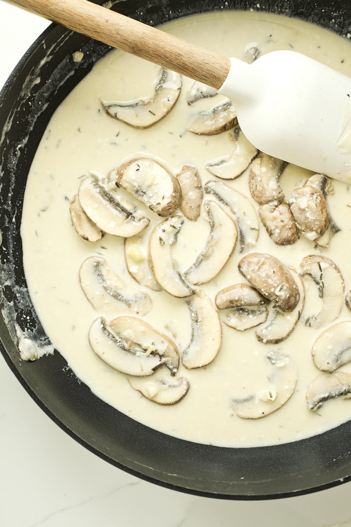 Creamy sauce with mushrooms in a pan