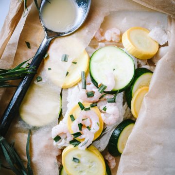 Dover sole filets topped with squash, zucchini and shrimp roasted in parchment paper