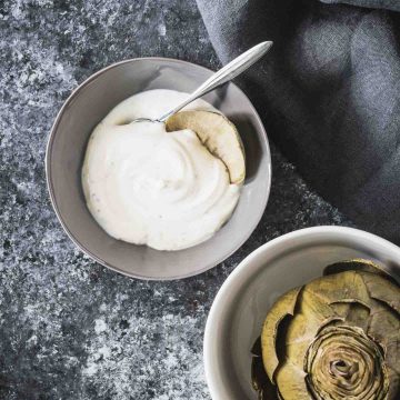 Artichoke dipping sauce with steamed artichoke