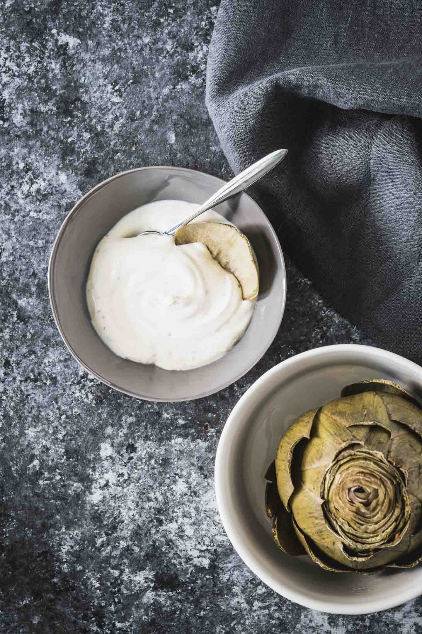 Artichoke dipping sauce with steamed artichoke