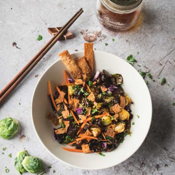 Crispy brussels sprouts topped with red cabbage, wontons and carrots