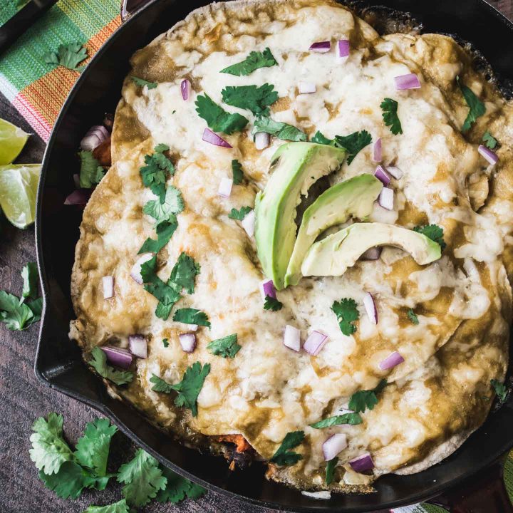 Black Bean Sweet potato enchiladas in a skillet photographed from overhead
