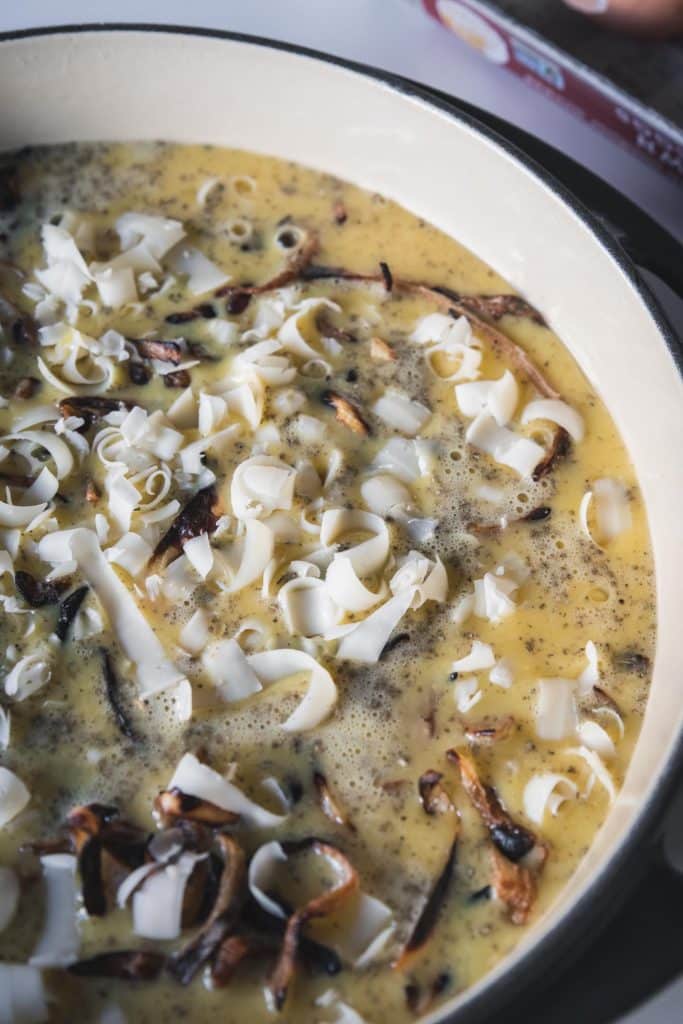 Egg mixture poured over frittata ingredients in pan