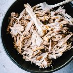 Cooked pulled pork in a black bowl