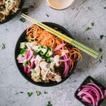 Turkey meatballs, spiralized veggies and sauce in a black matte bowl