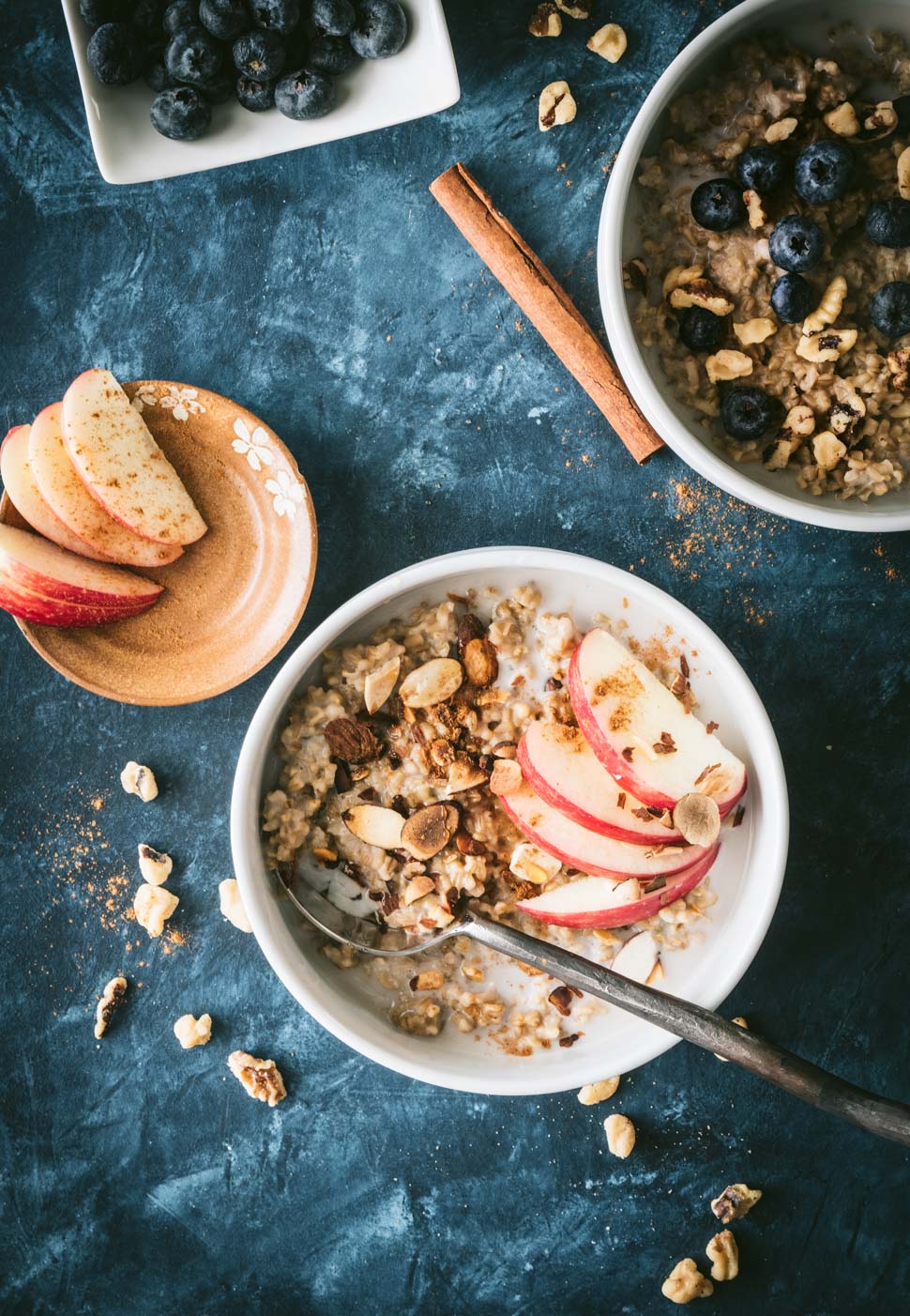 Instant Pot steel cut oats topped with apple slices, nuts and maple syrup