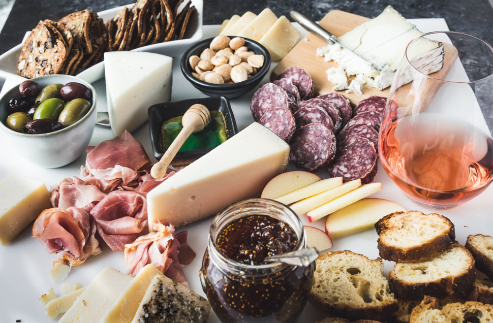 Close up of cheese and meats on a white background