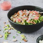 Quinoa topped with grilled chicken, goat cheese and bright raspberry dressing