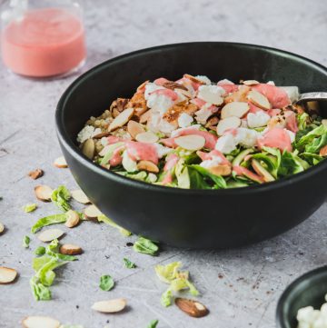 Quinoa topped with grilled chicken, goat cheese and bright raspberry dressing