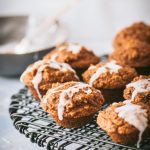 Close up of mini pumpkin muffins on a black wire rack