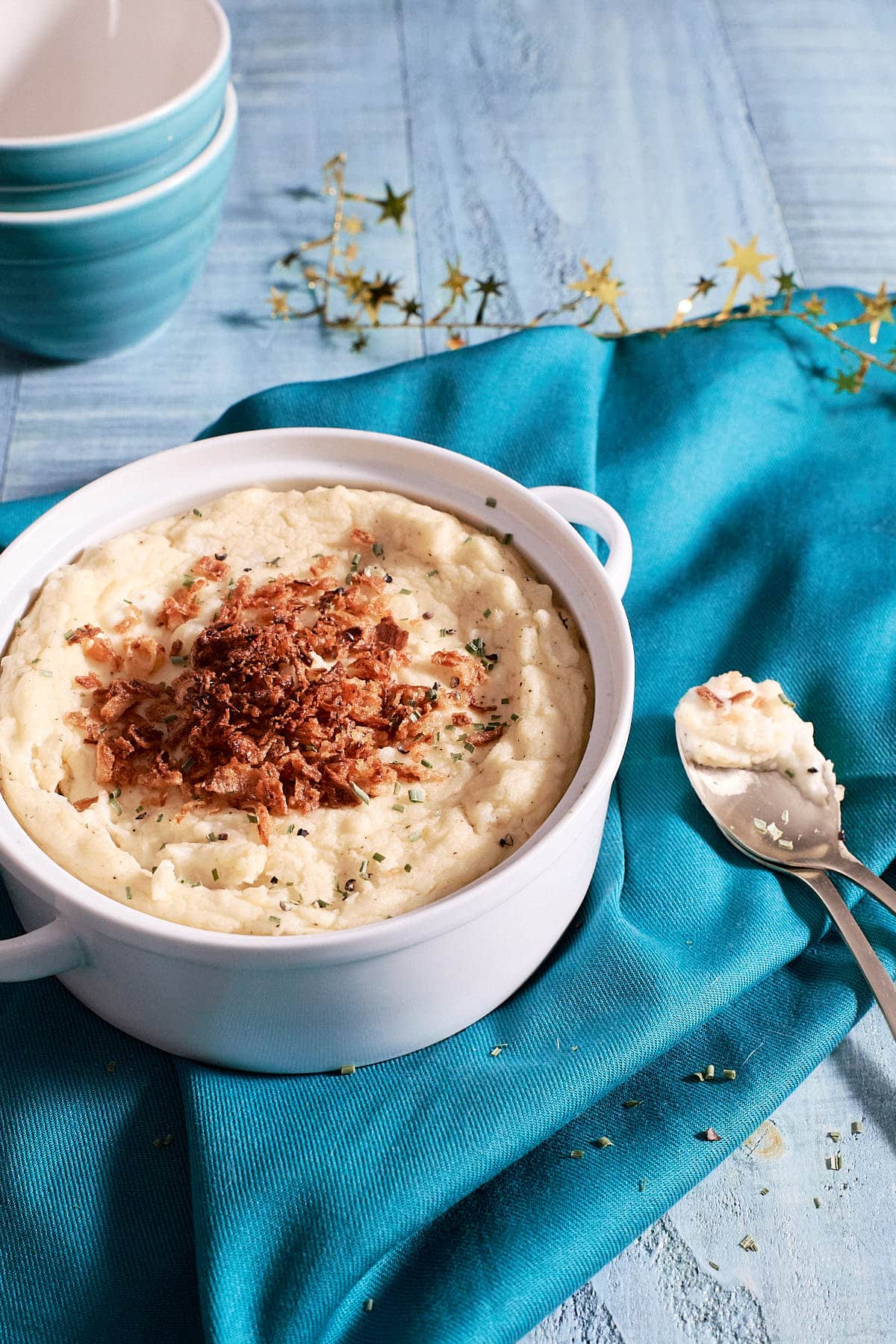 White serving dish filled with mashed potatoes
