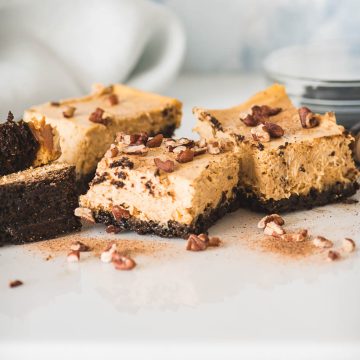 Pumpkin cheesecake bars dusted with ground nutmeg