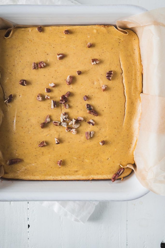 Pumpkin cheesecake in a white baking pan shot from overhead