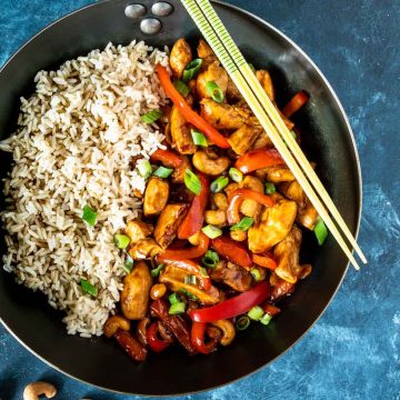 Pan with brown rice and stir fried cashew chicken shot from overhead