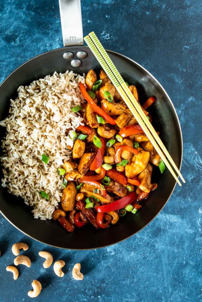 Pan with brown rice and stir fried cashew chicken shot from overhead