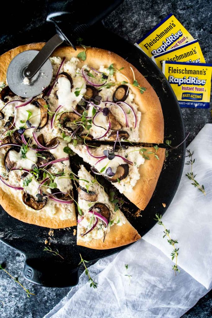Ricotta mushroom pizza with two slices cut shot from overhead
