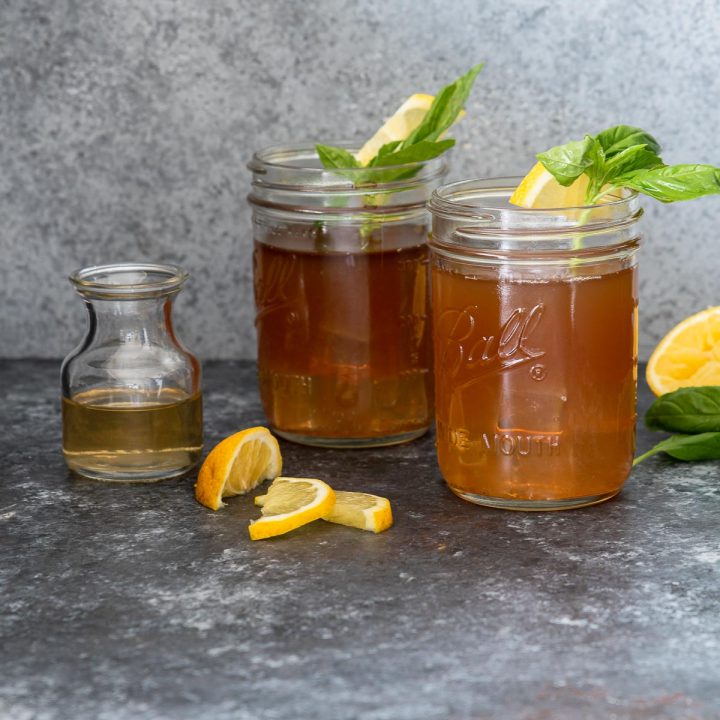 Two bourbon Arnold Palmers in Mason jars