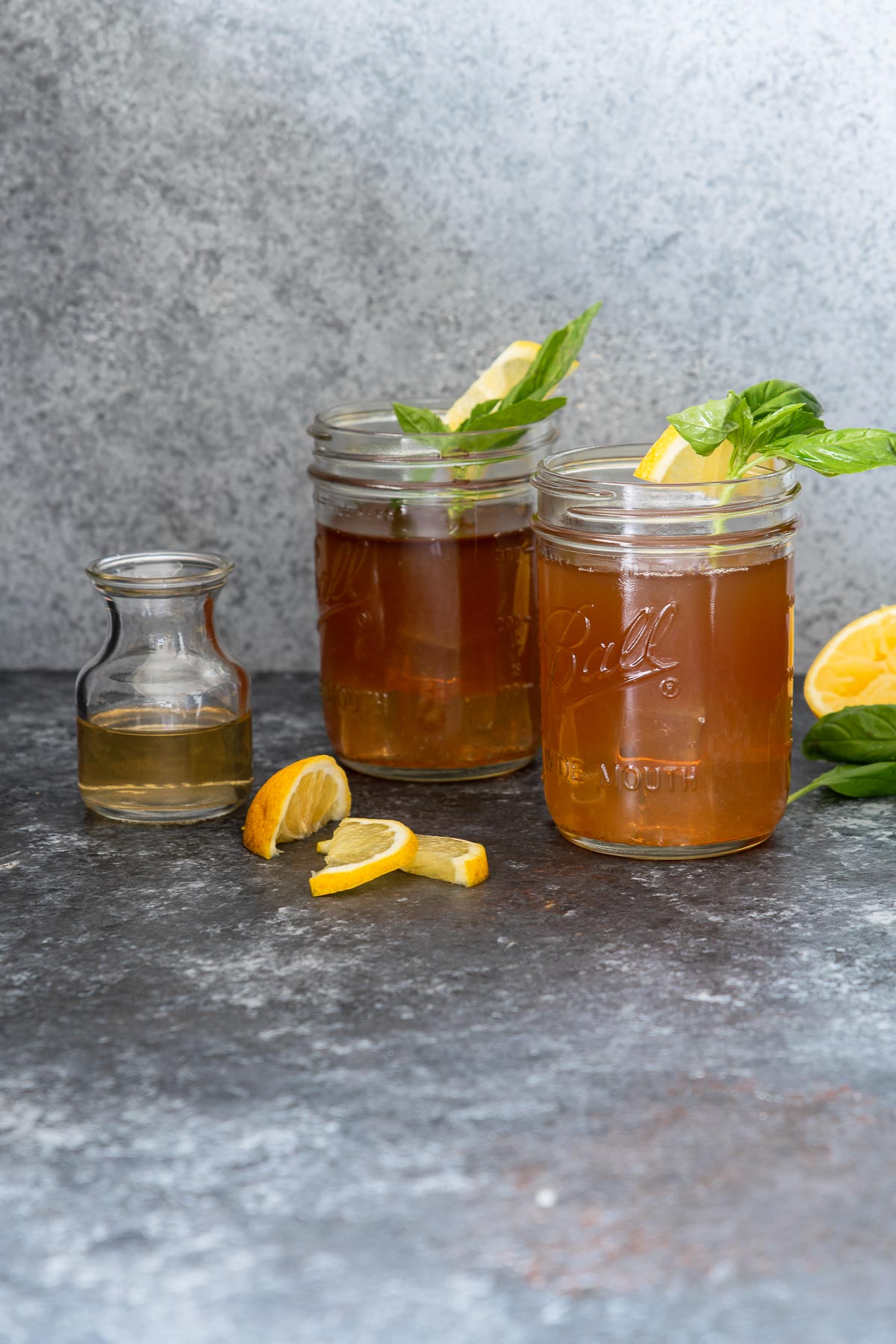Two bourbon Arnold Palmers in Mason jars